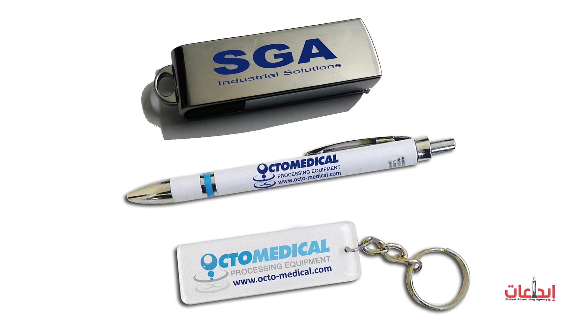 فلاشة USB بشعار SGA وقلم وميدالية بشعار Octomedical من الهدايا الدعائية